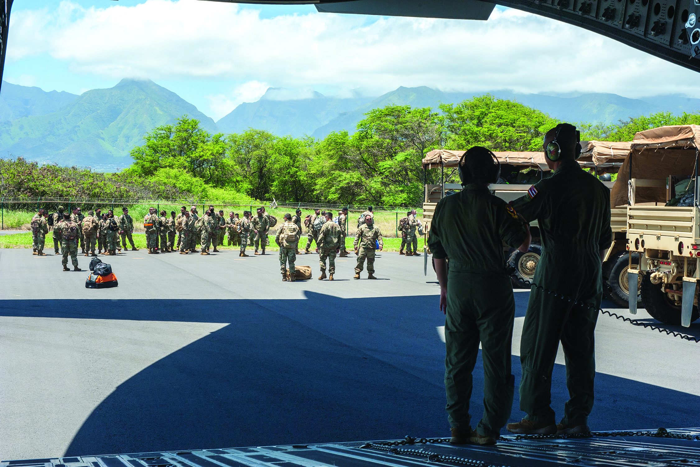 Staff Sgt. Virginia Inouye and Master Sgt. Brandon
        Sarceda, 204th Airlift Squadron loadmasters,
        deliver Hawaii Air National Guard Airmen and
        Soldiers April 17, 2020, to Kahului Airport, Maui,
        Hawaii. Guardsmen were airlifted from Oahu
        on a C-17 Globemaster III to minimize the risk
        of exposure of disease at airports. Hundreds of
        guardsmen have been activated to assist the State
        of Hawaii’s response to COVID-19. (U.S. Air Force
        photo by Senior Airman John Linzmeier)